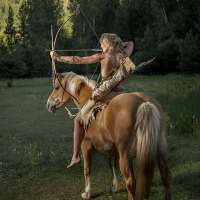 Lynx on horseback with bow and arrow